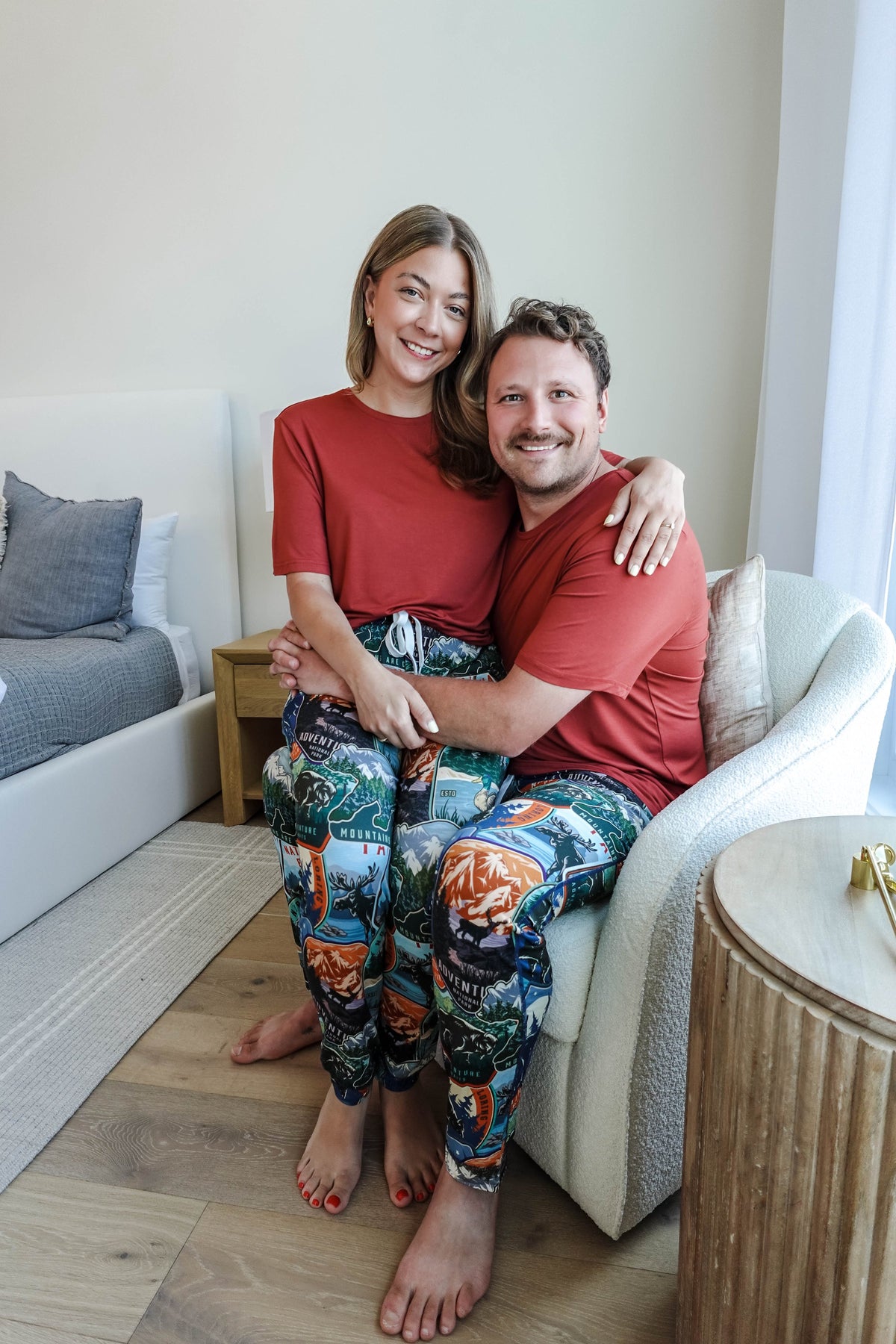 man and woman in matching tee and jogger set sitting in a chair