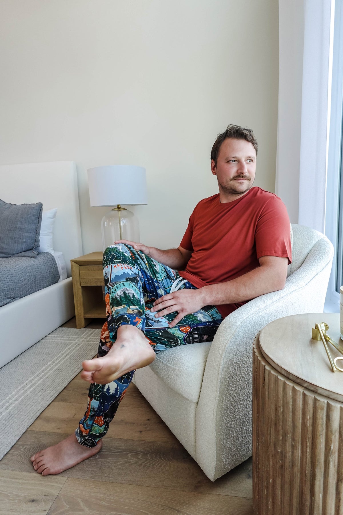 man  in matching tee and jogger set sitting in a chair